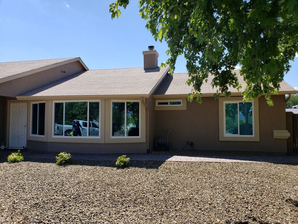 A house with a lot of windows and a tree in front of it.