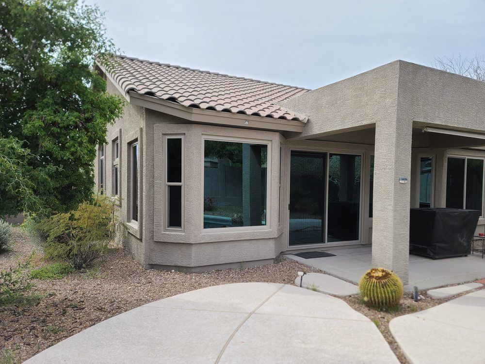 A house with a lot of windows and a sliding glass door.