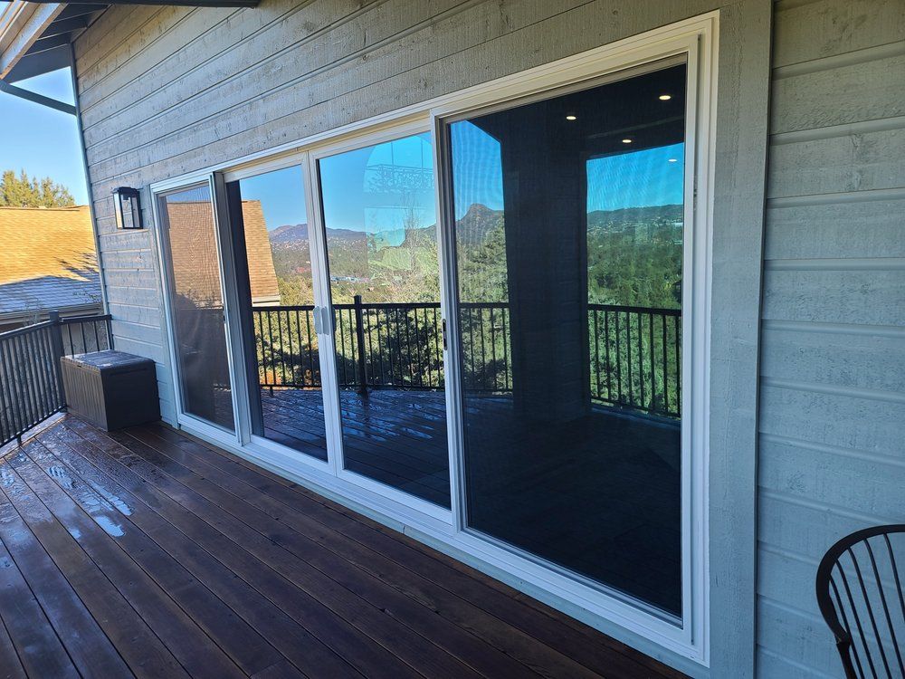 There is a large sliding glass door on the side of the house.