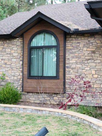 A brick house with a large arched window