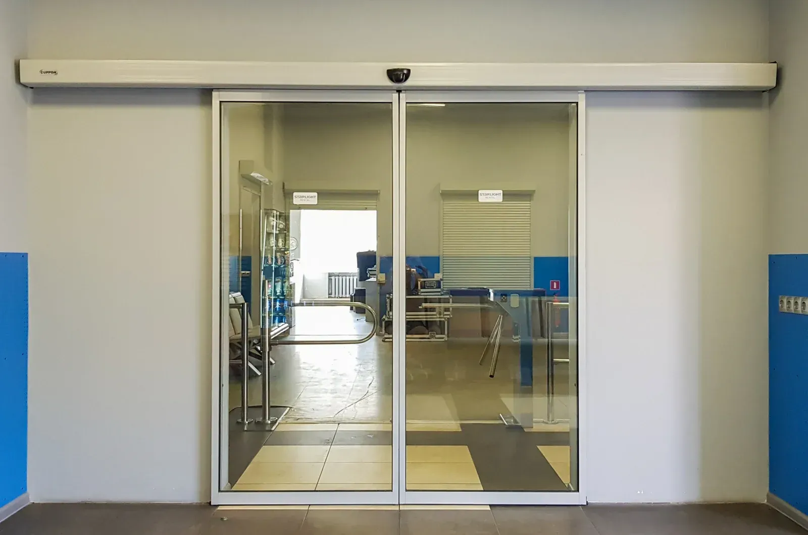 A sliding glass door is open in a hallway.