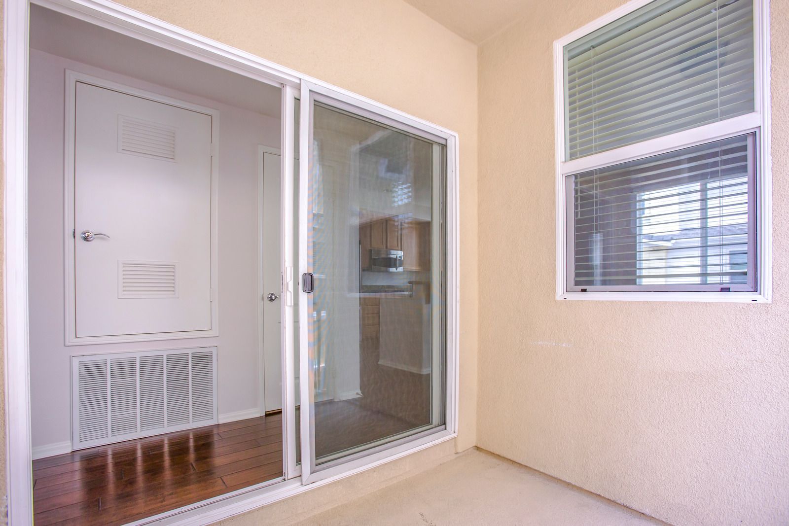 A room with a sliding glass door and a window