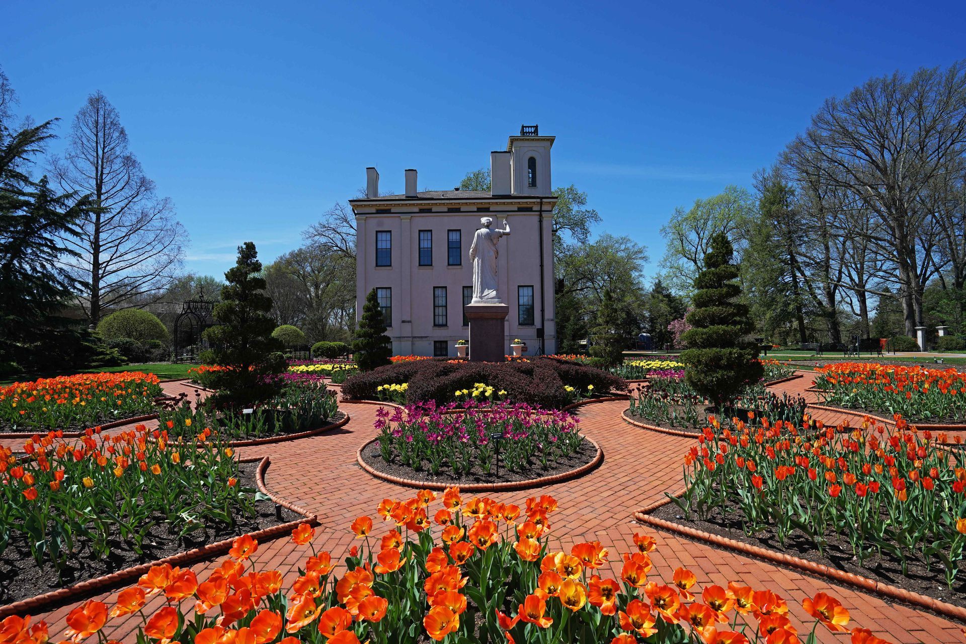 A beautiful flower garden in the courtyard of a colonial building in a St. Louis Park