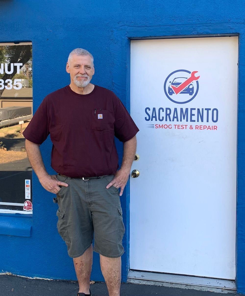 Otto standing in front of a door that says Sacramento Smog Test and Repair