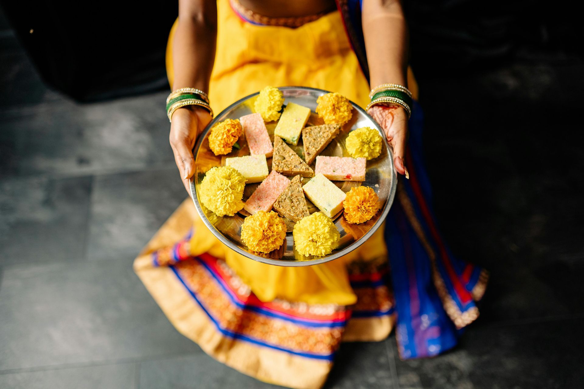 A woman is holding a plate of food in her hands.