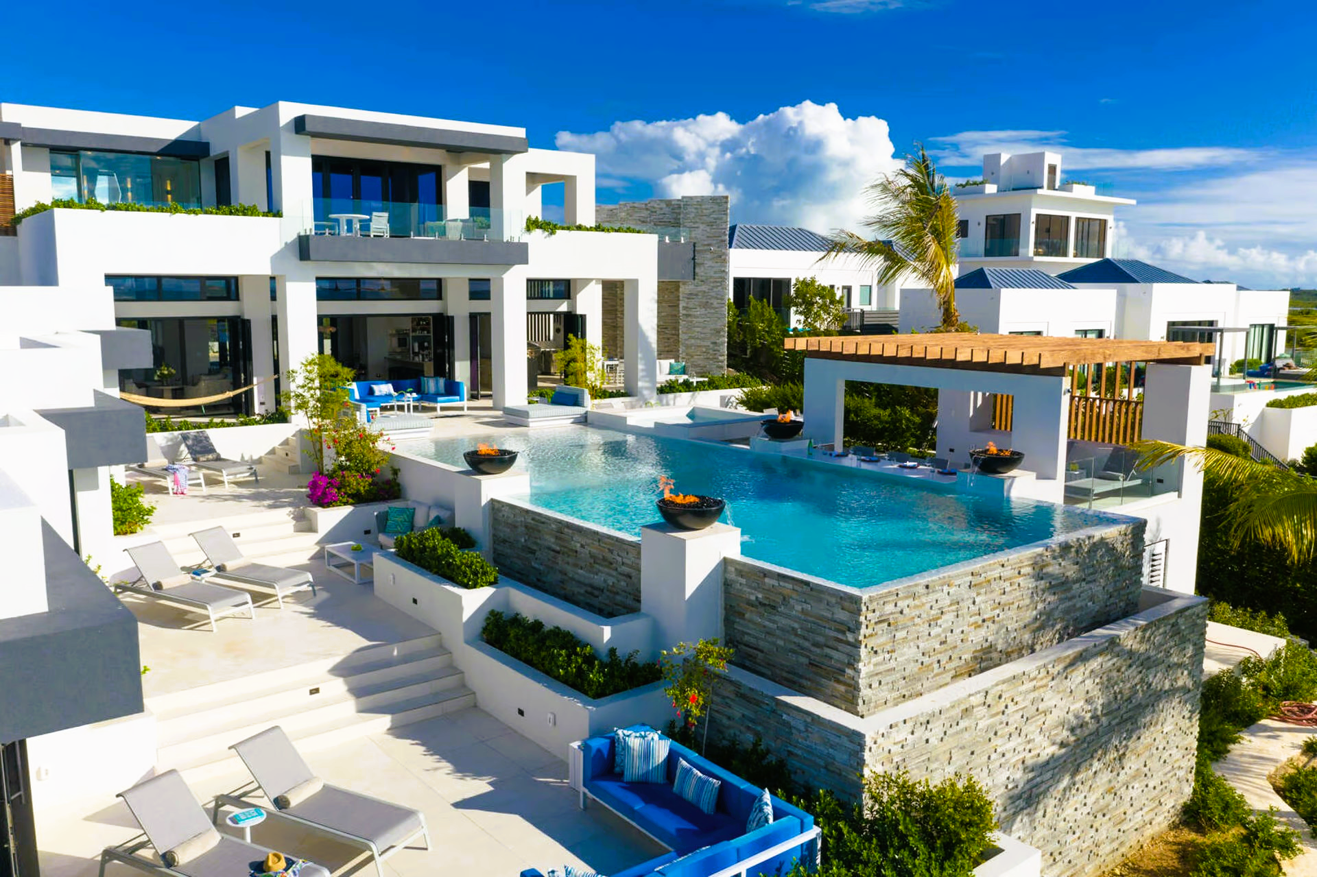 A large white house with a swimming pool in front of it