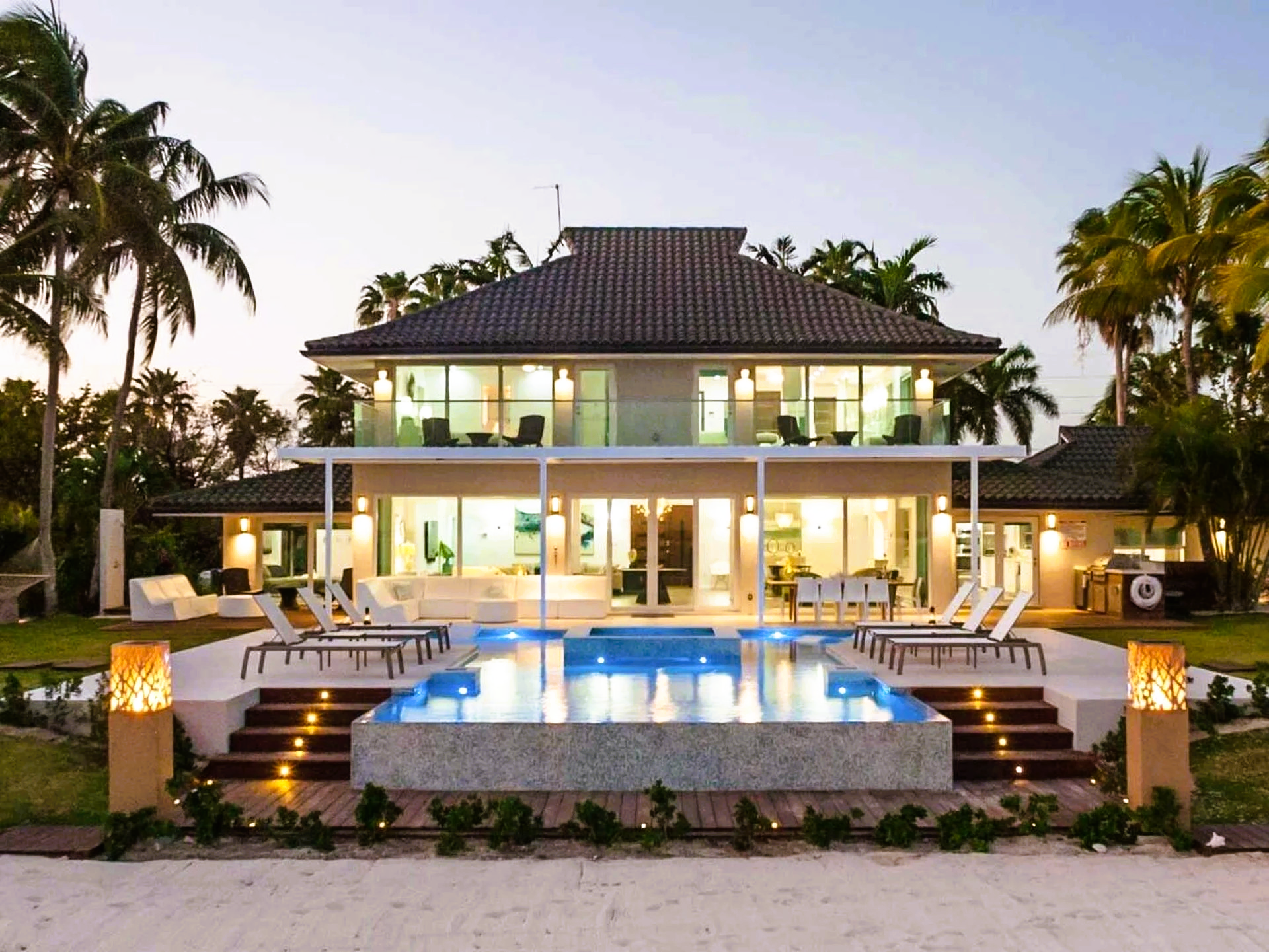 A large house with a swimming pool in front of it