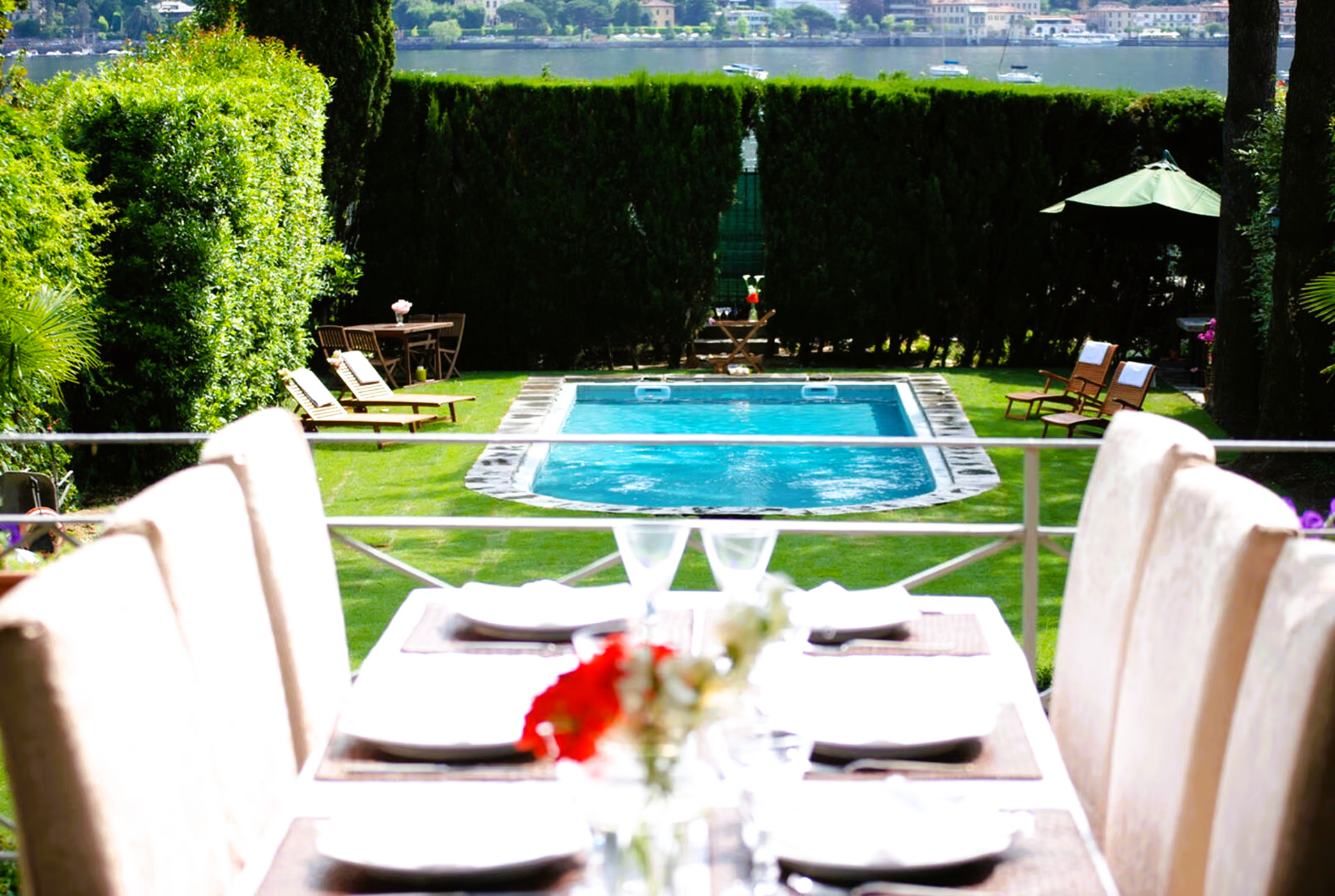 A dining table with a view of a swimming pool