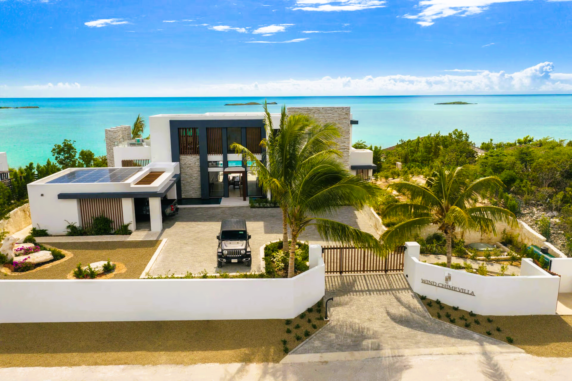 An aerial view of a house with a car parked in front of it.
