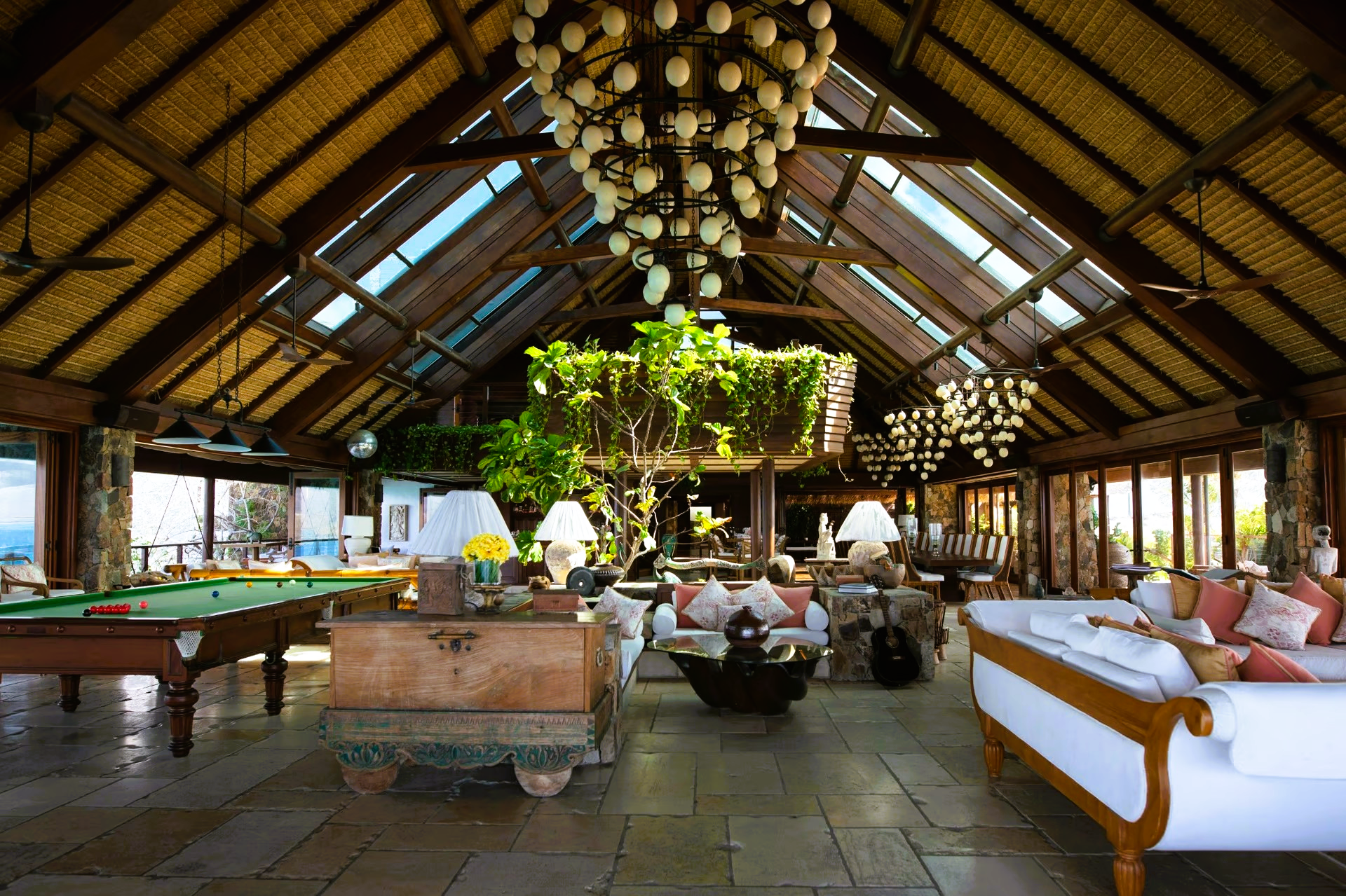 A large room with a pool table and a chandelier