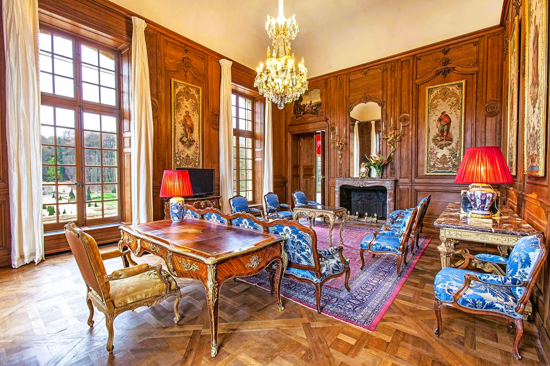 A living room filled with furniture and a chandelier.