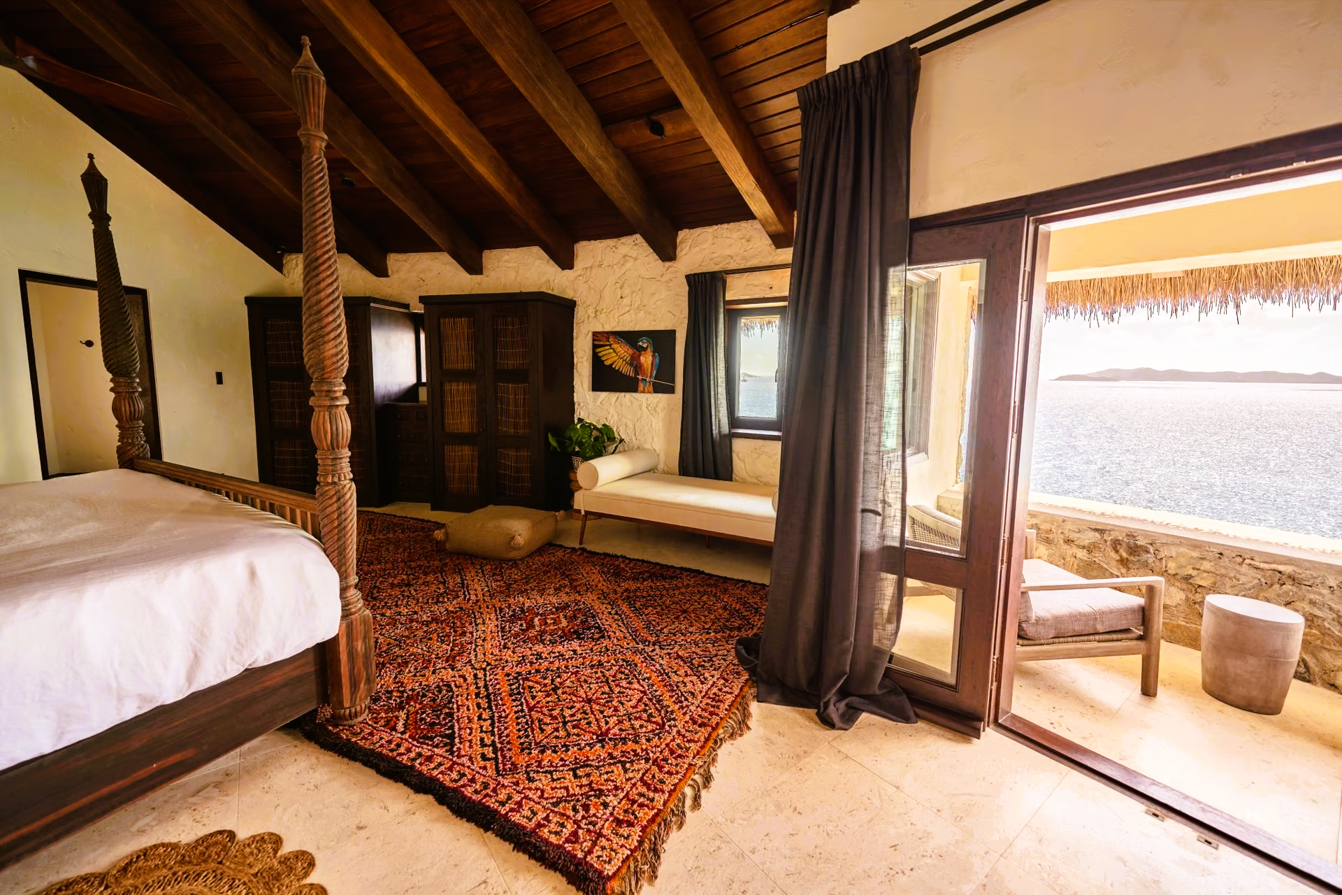A bedroom with a four poster bed and a rug