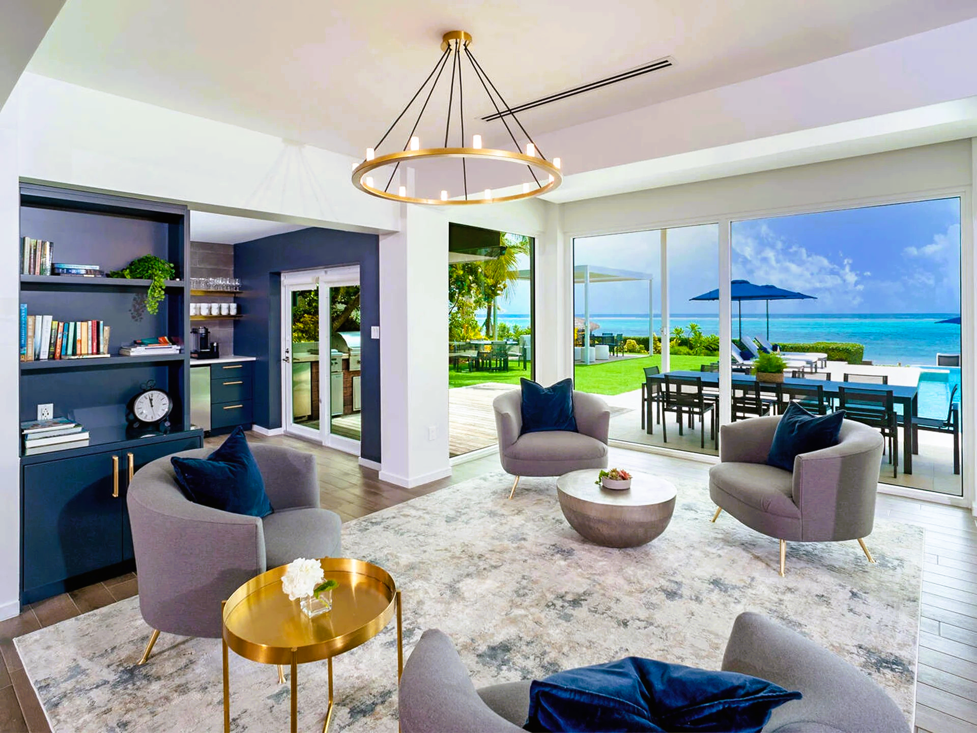 A living room with a lot of furniture and a view of the ocean.