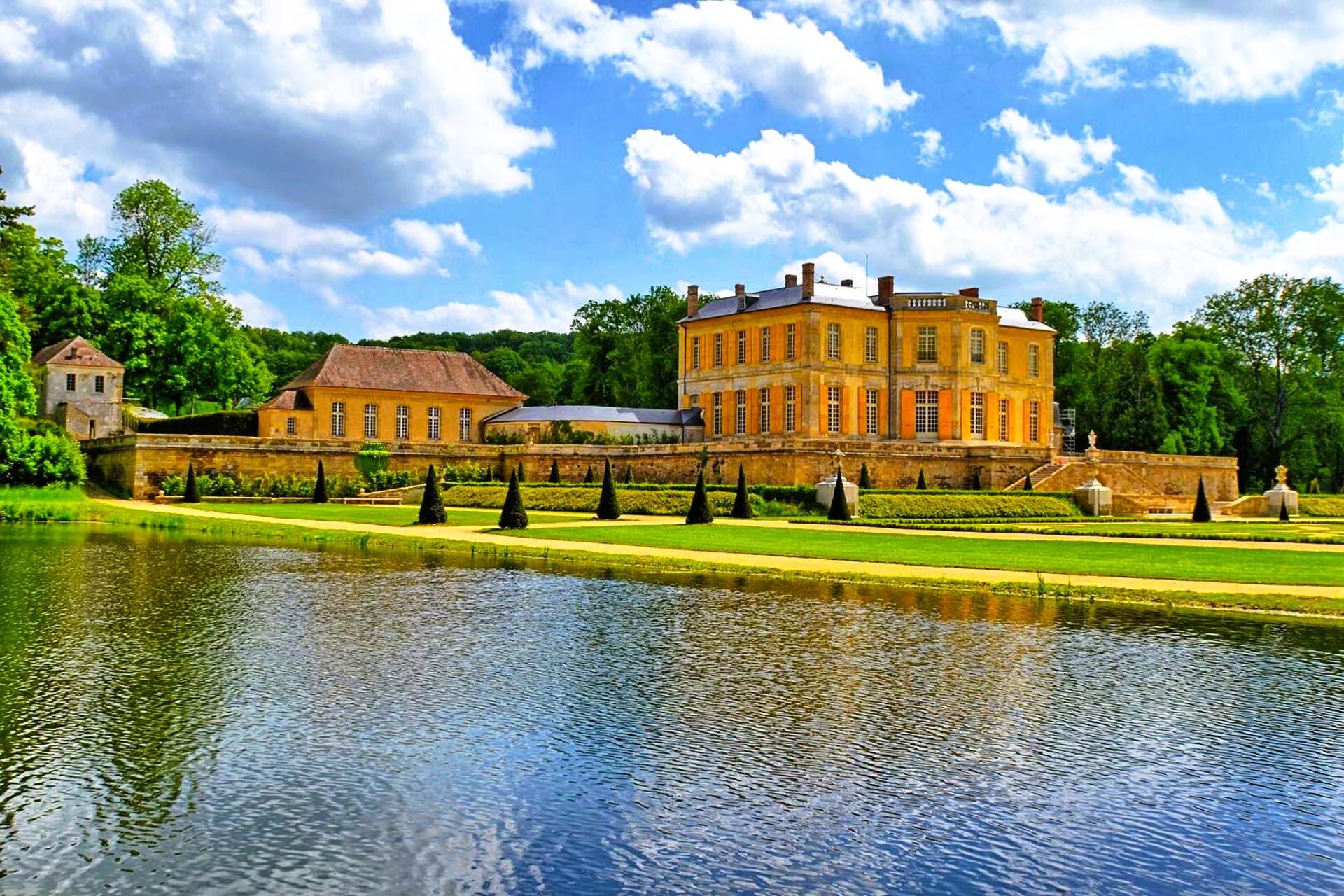 A large yellow building is sitting next to a body of water.