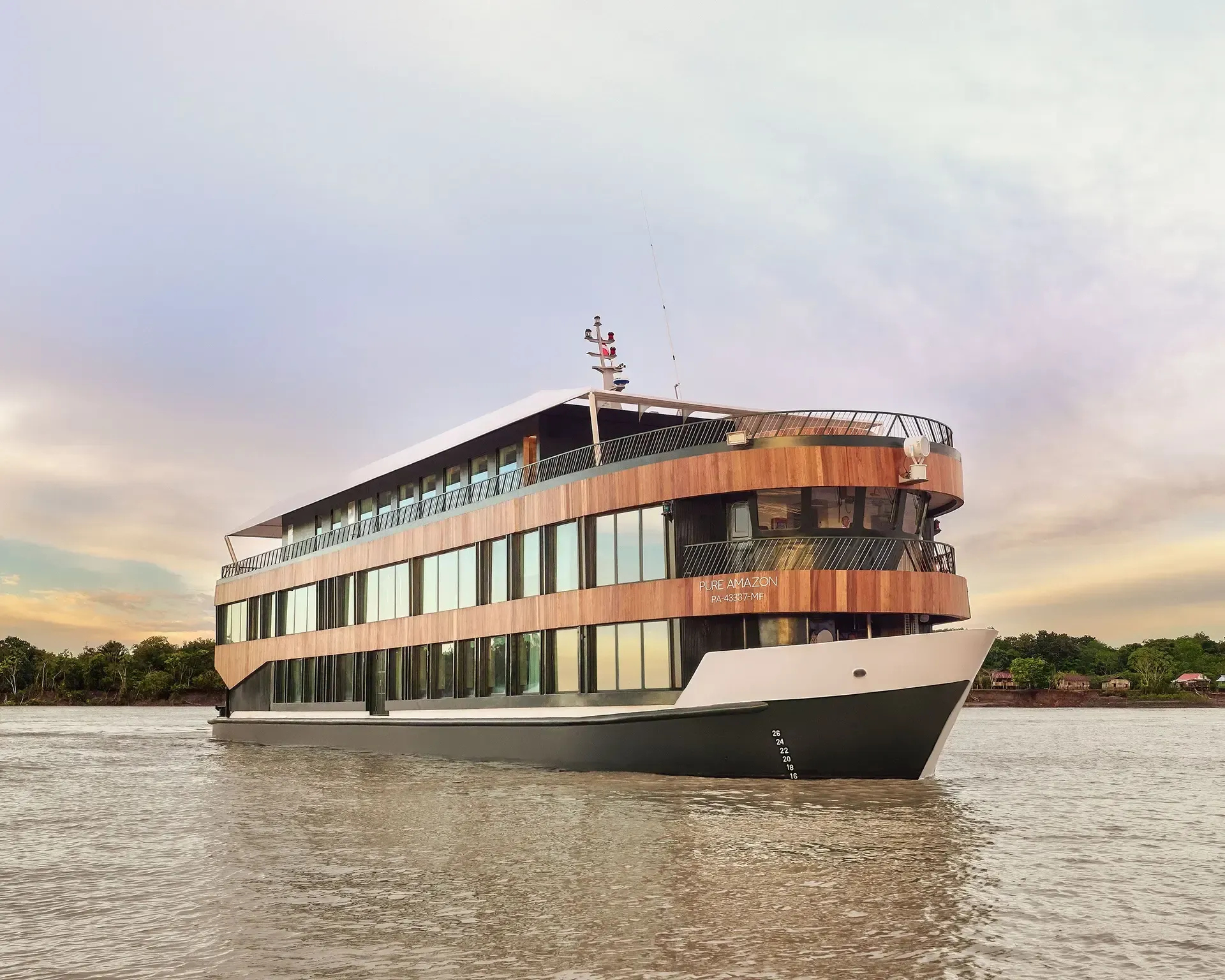 River cruise ship with wooden accents on a river, under a cloudy sky.