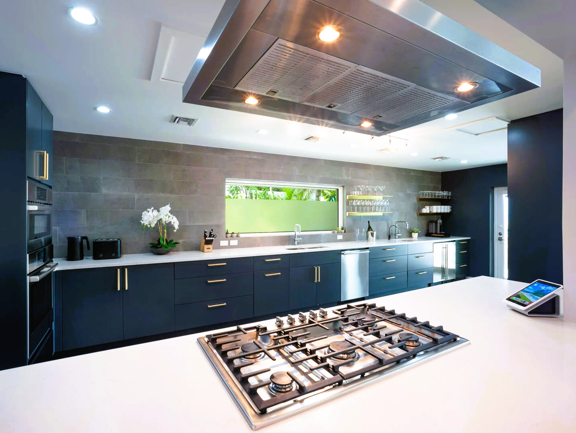 A kitchen with stainless steel appliances and a large stove top oven.