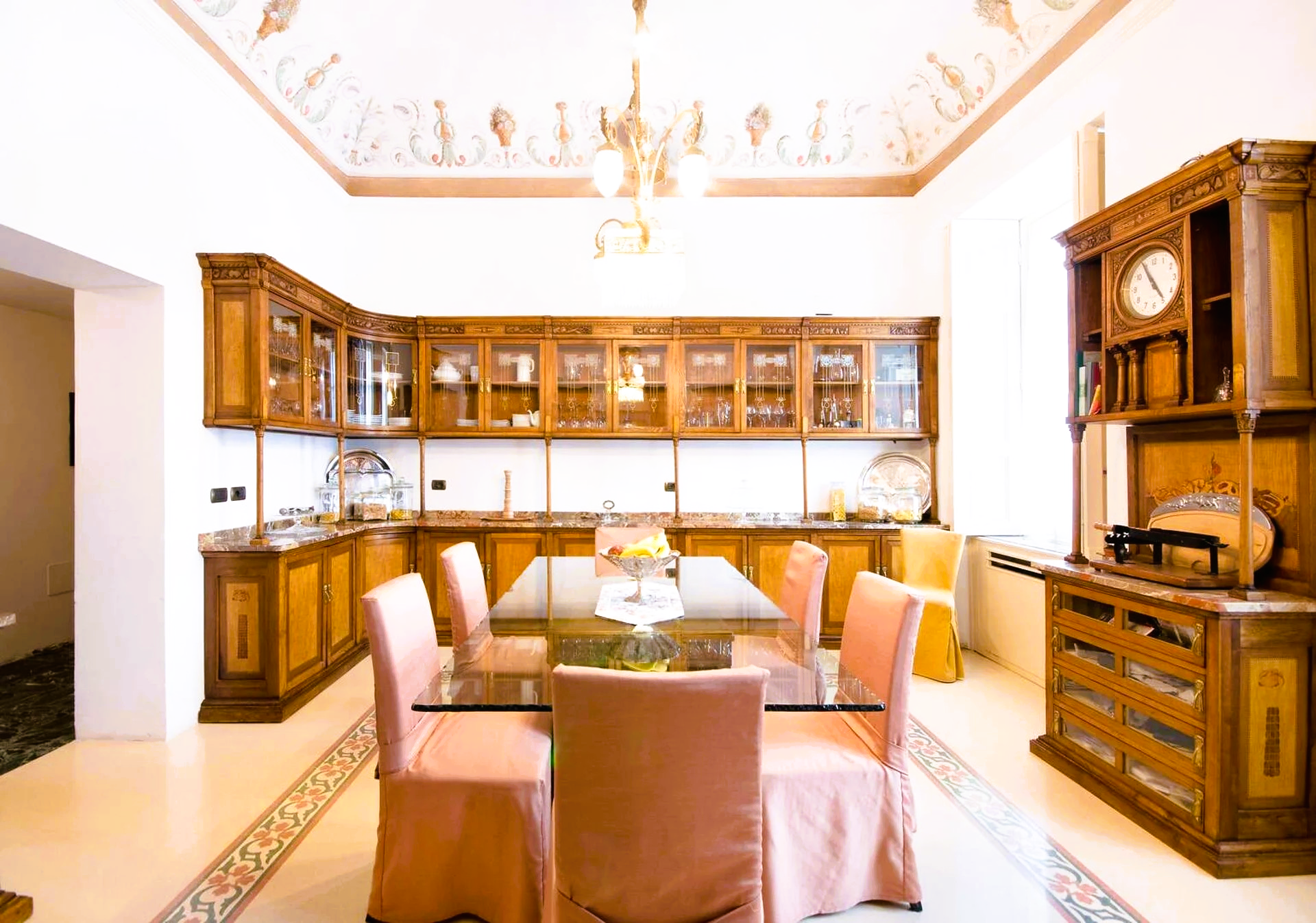A dining room with a glass table and chairs