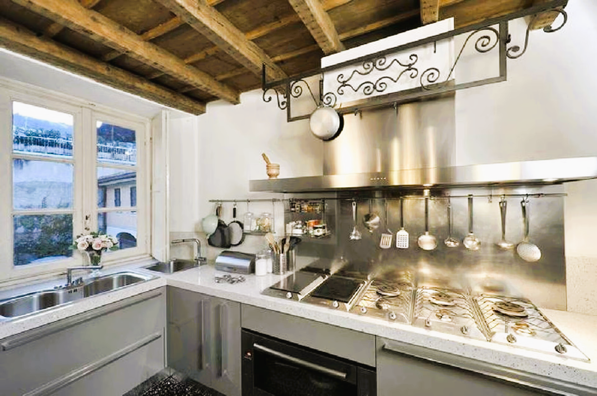 A kitchen with stainless steel appliances and a stove top oven.