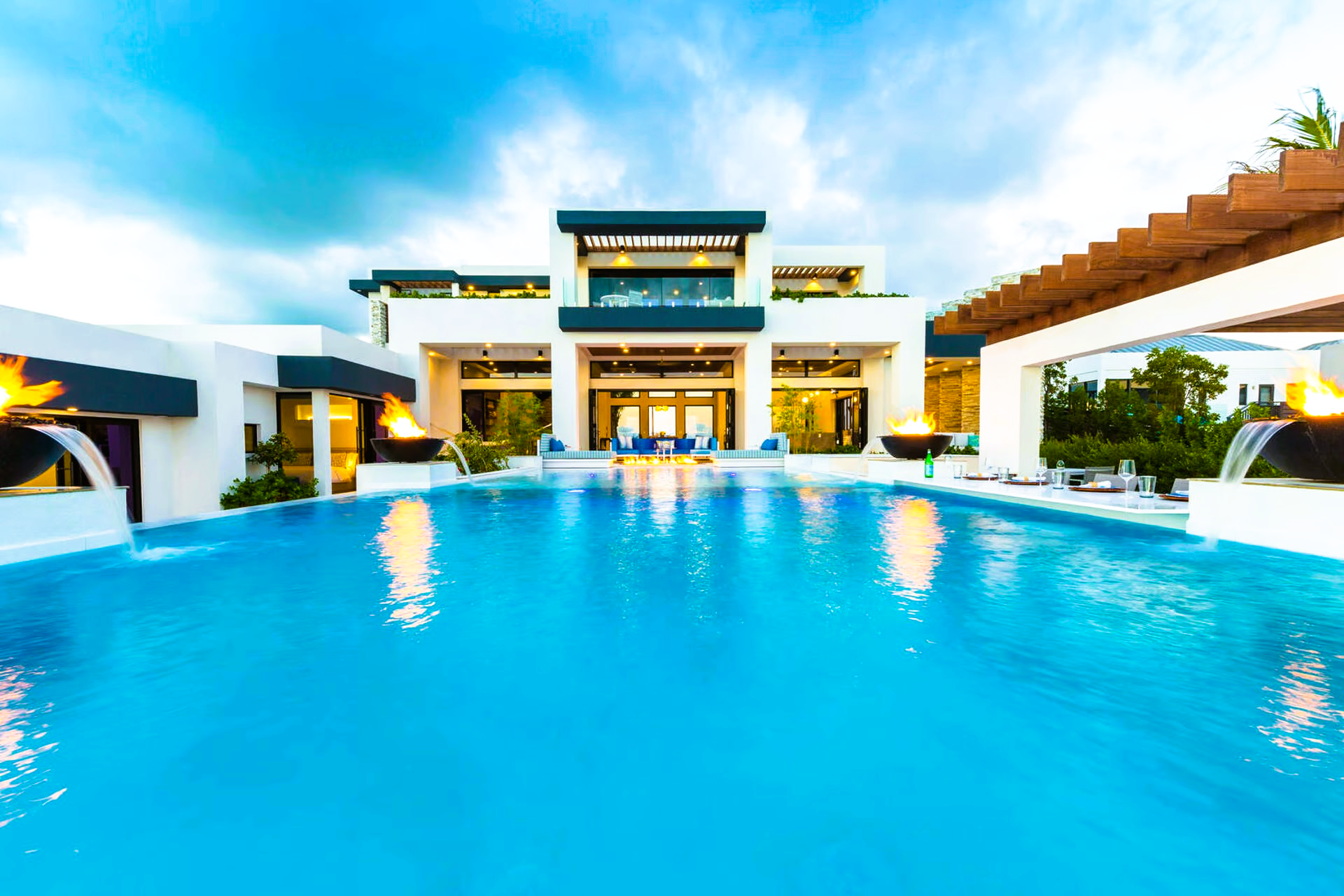 A large house with a swimming pool in front of it.