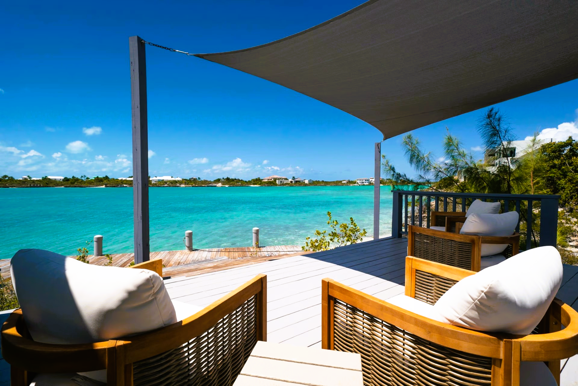 Two chairs on a deck overlooking the ocean