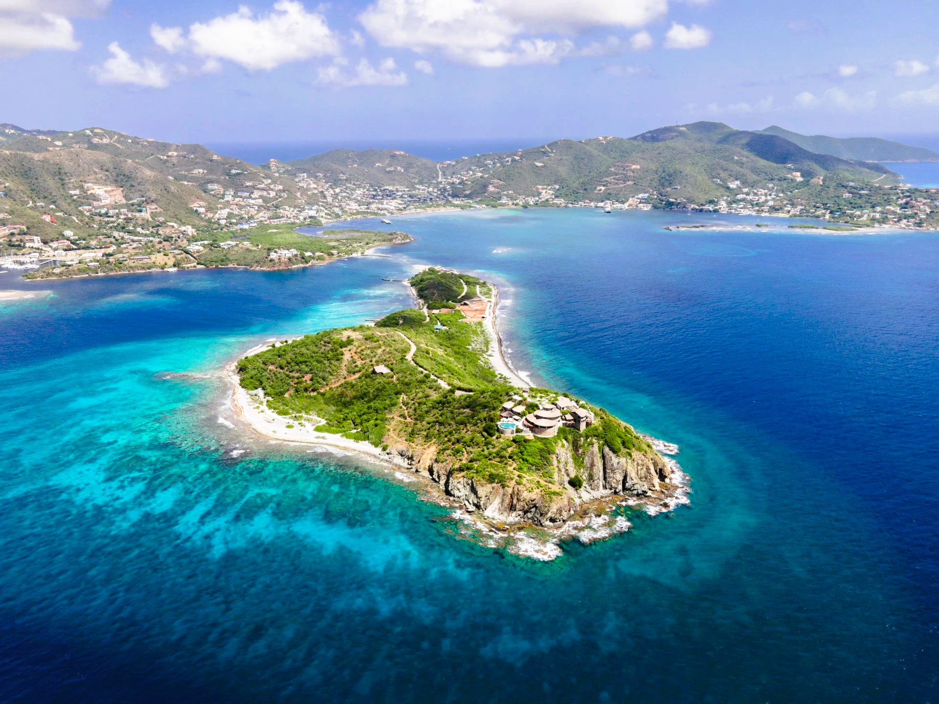 An aerial view of a small island in the middle of the ocean.