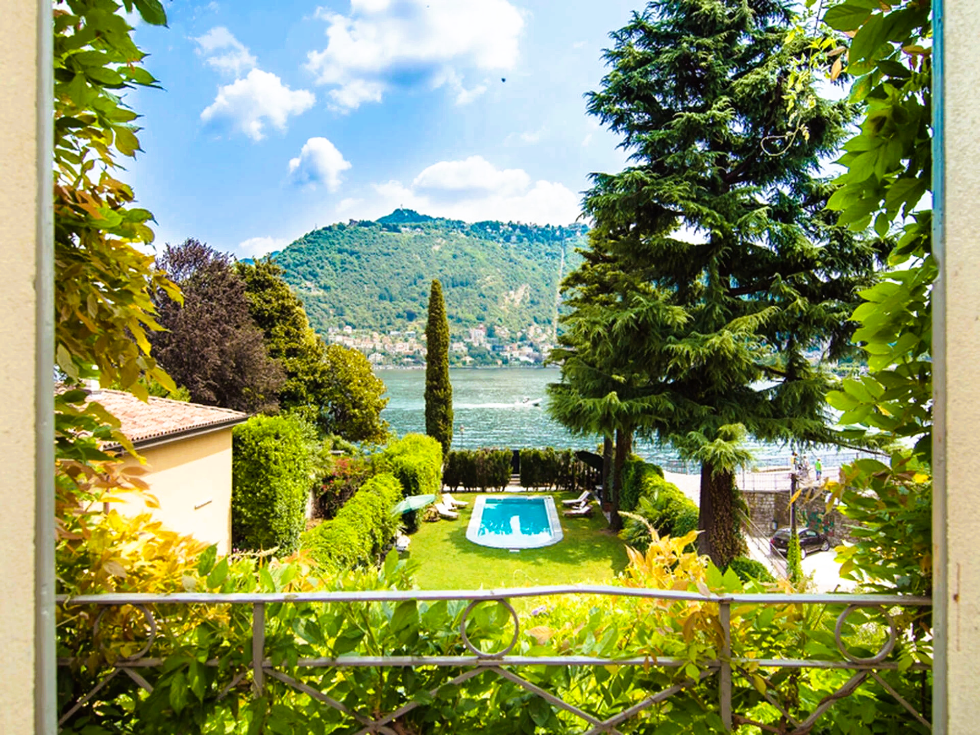A picture of a swimming pool with mountains in the background