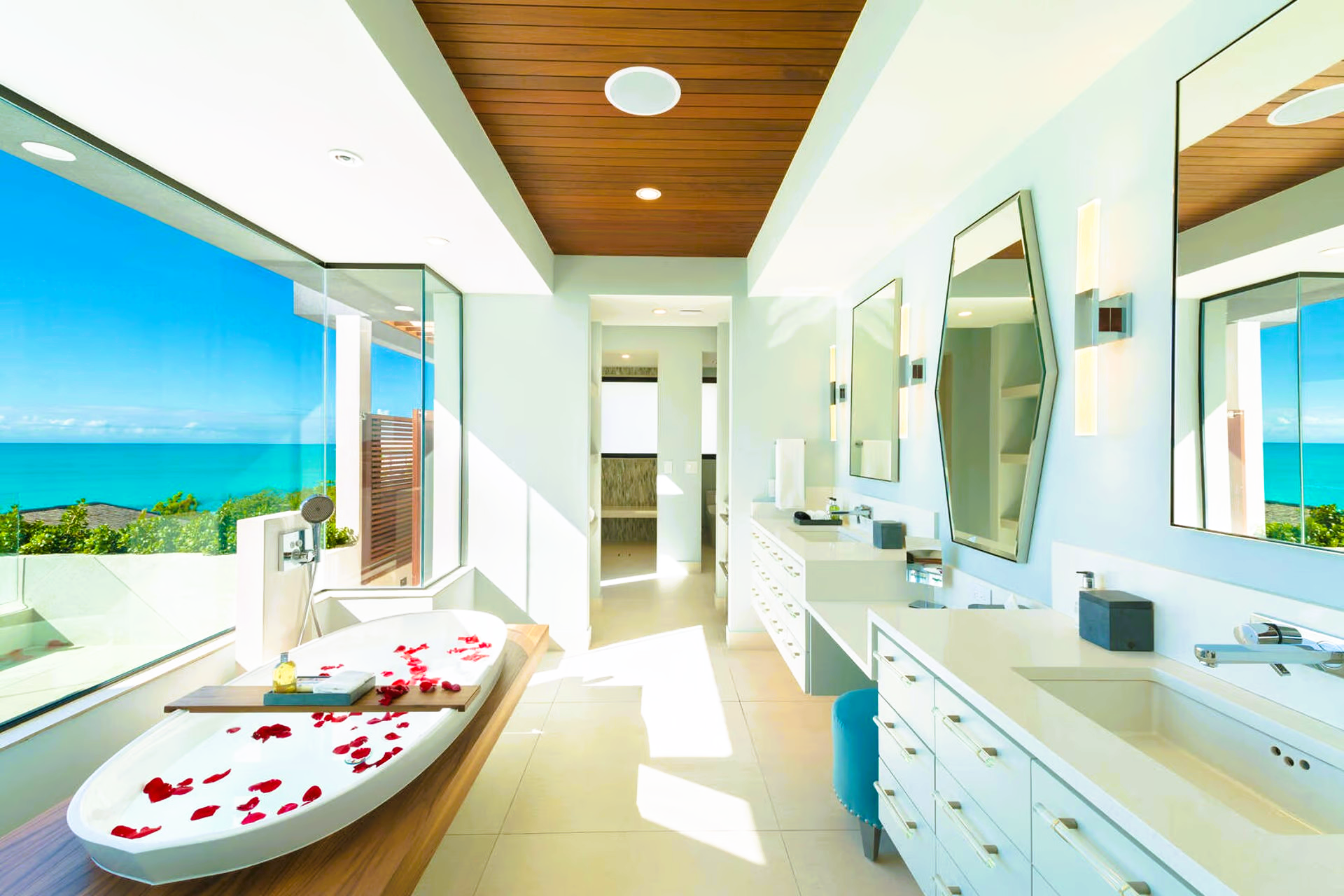 A bathroom with a large tub and a view of the ocean