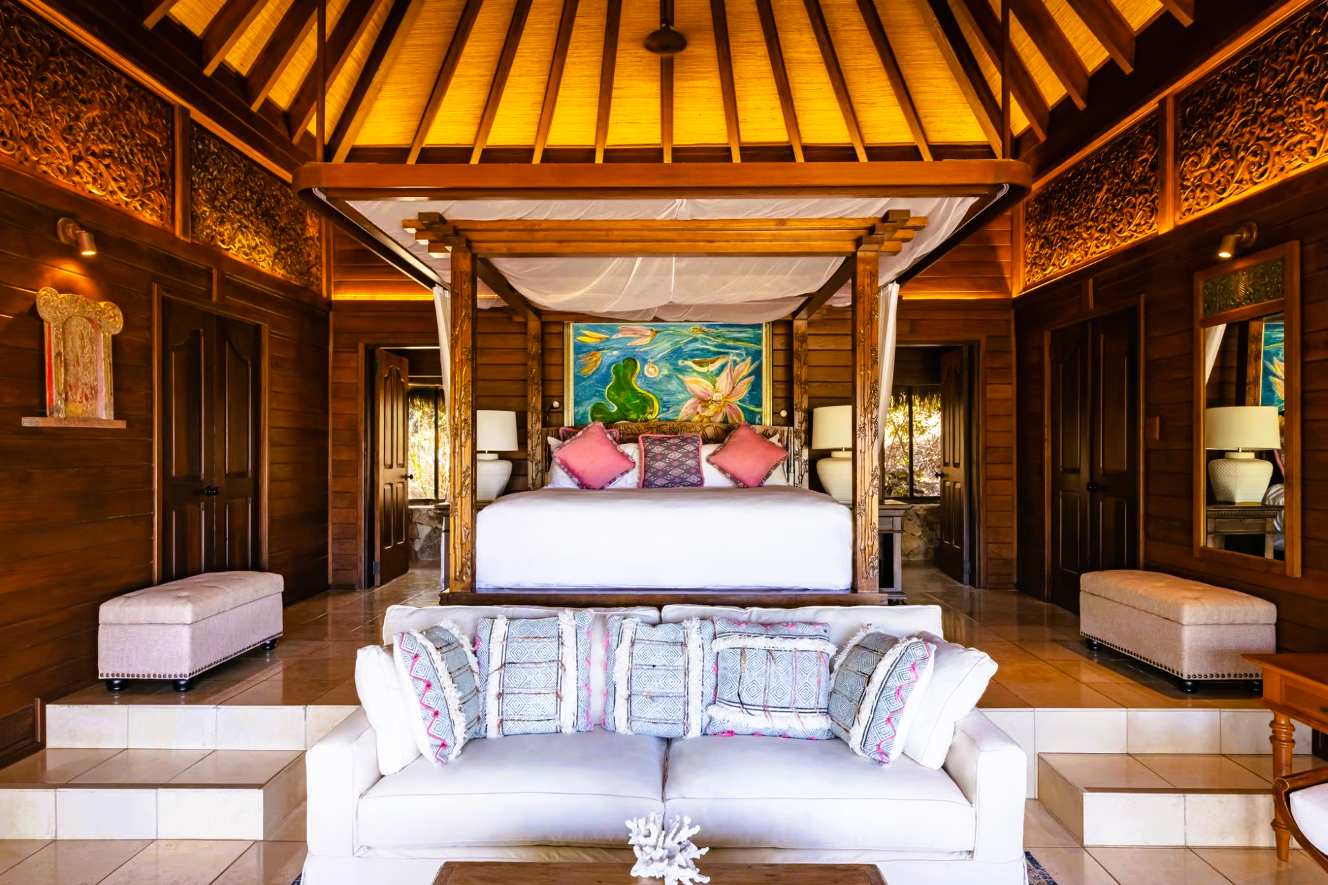 A bedroom with a canopy bed and a couch