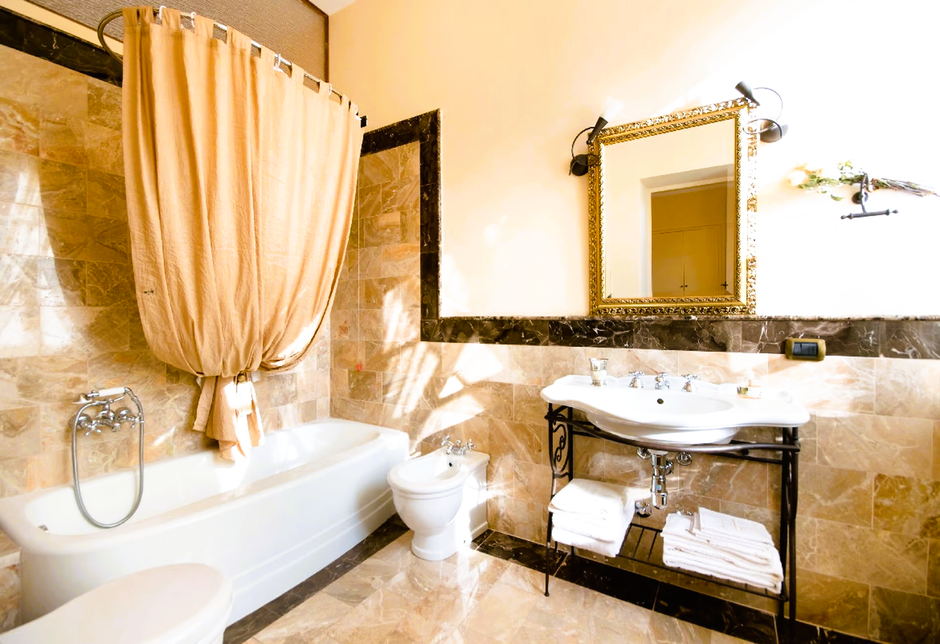A bathroom with a bathtub , sink , toilet and mirror