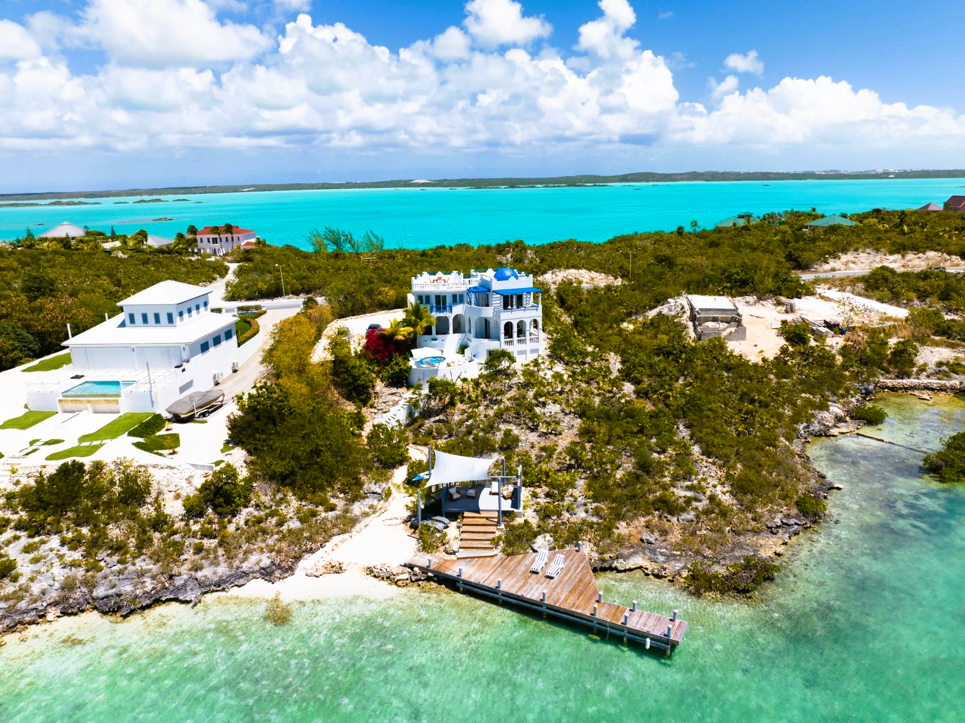 An aerial view of a large house on a small island