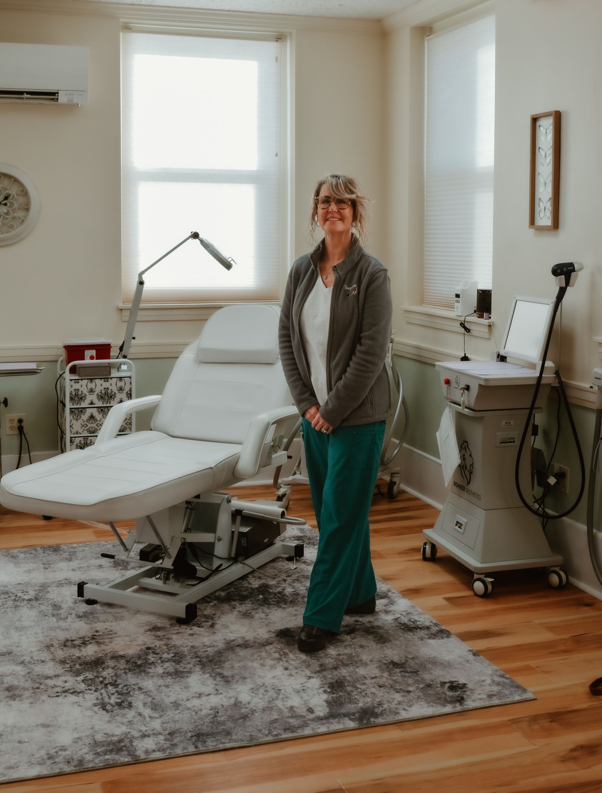 A woman is standing in a room with a chair and a machine.