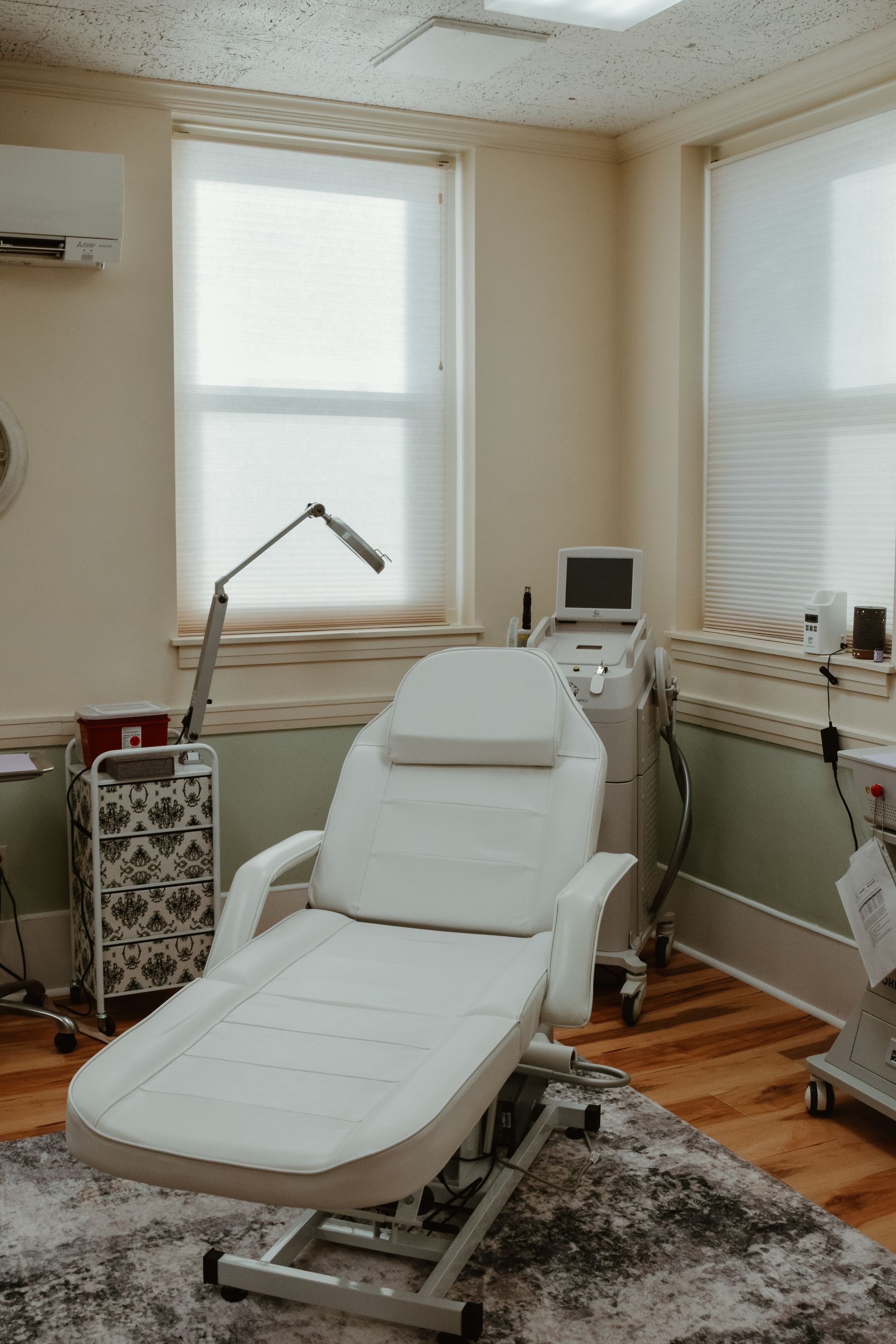 A white couch is sitting in a room next to a window.