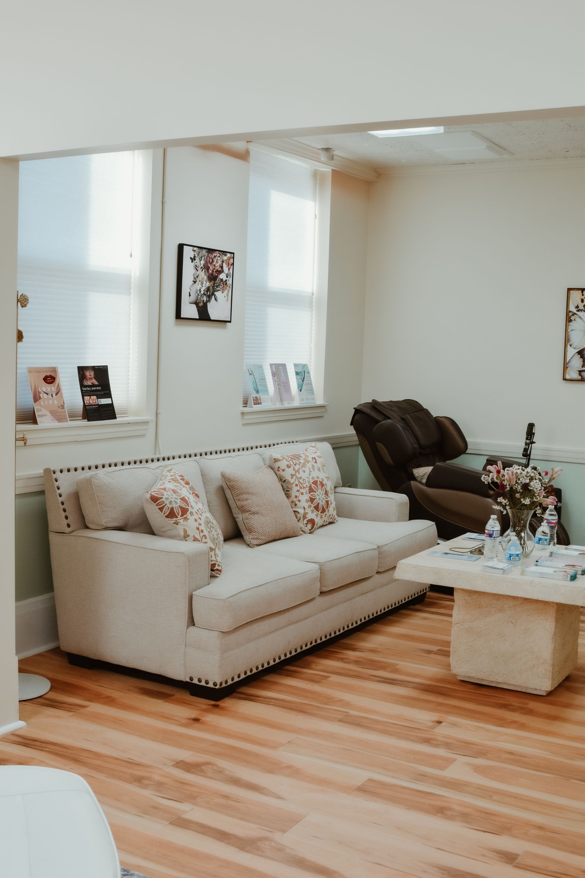 A living room with a couch , chairs , and a coffee table.