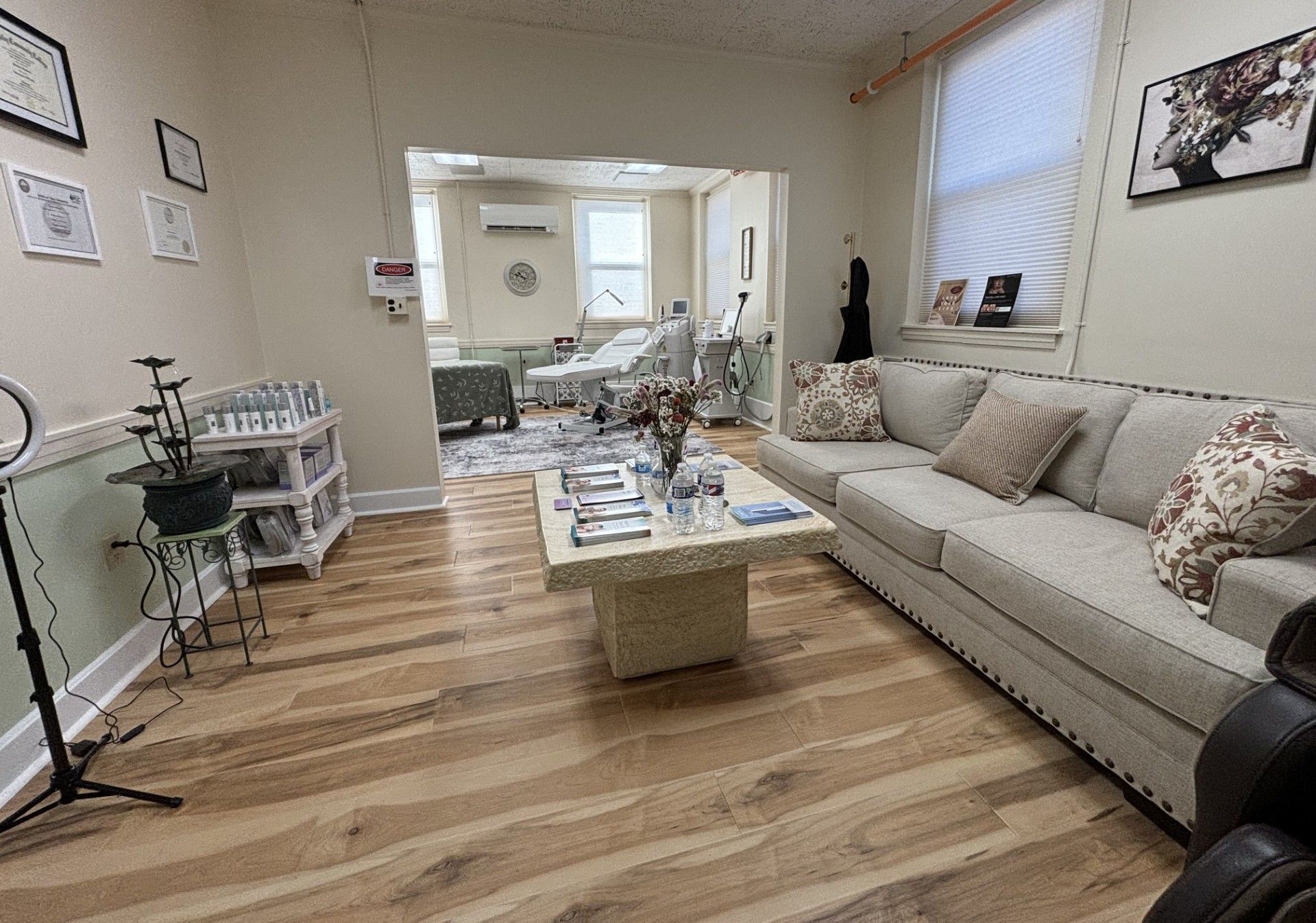 A living room with a couch , coffee table and chairs.