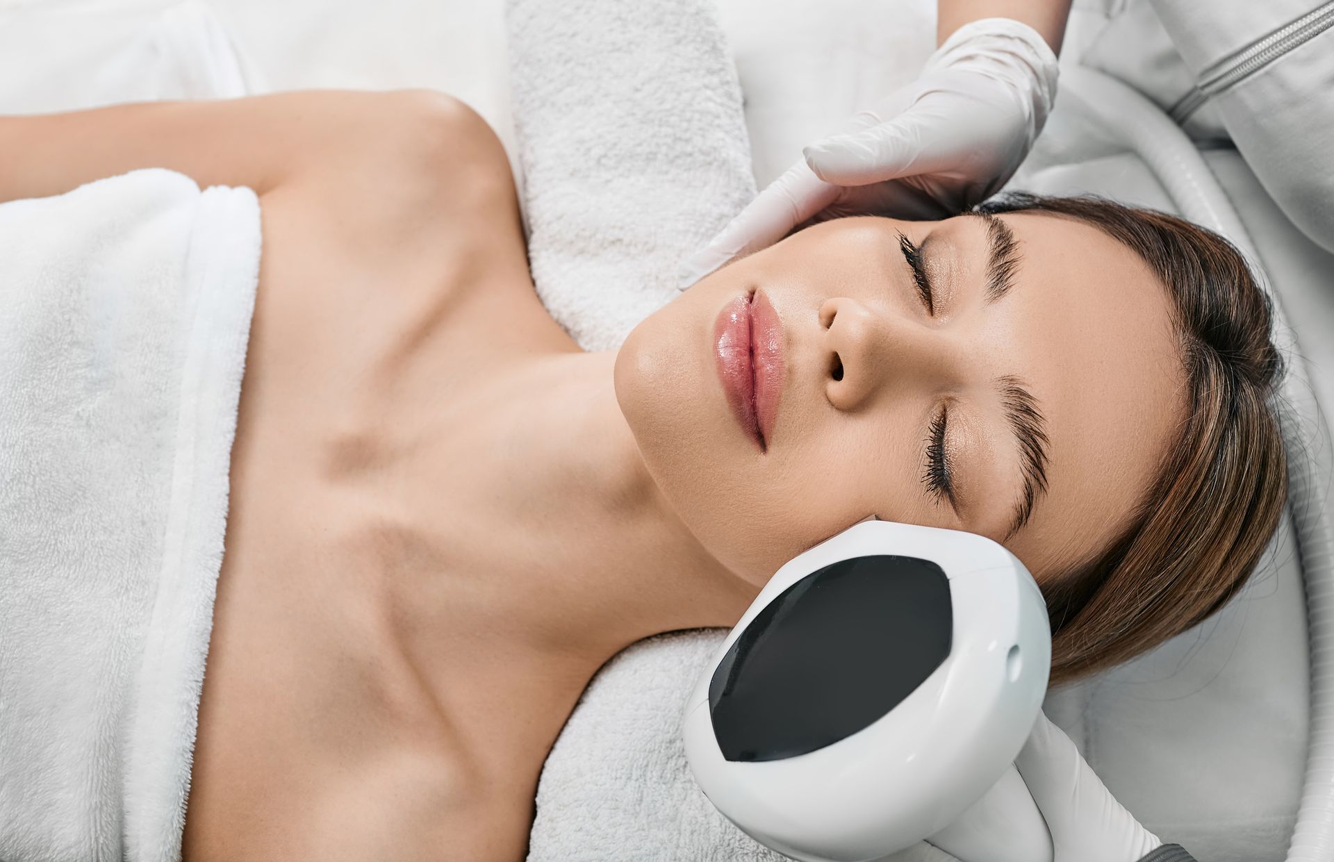 A woman is getting a facial treatment in a spa.