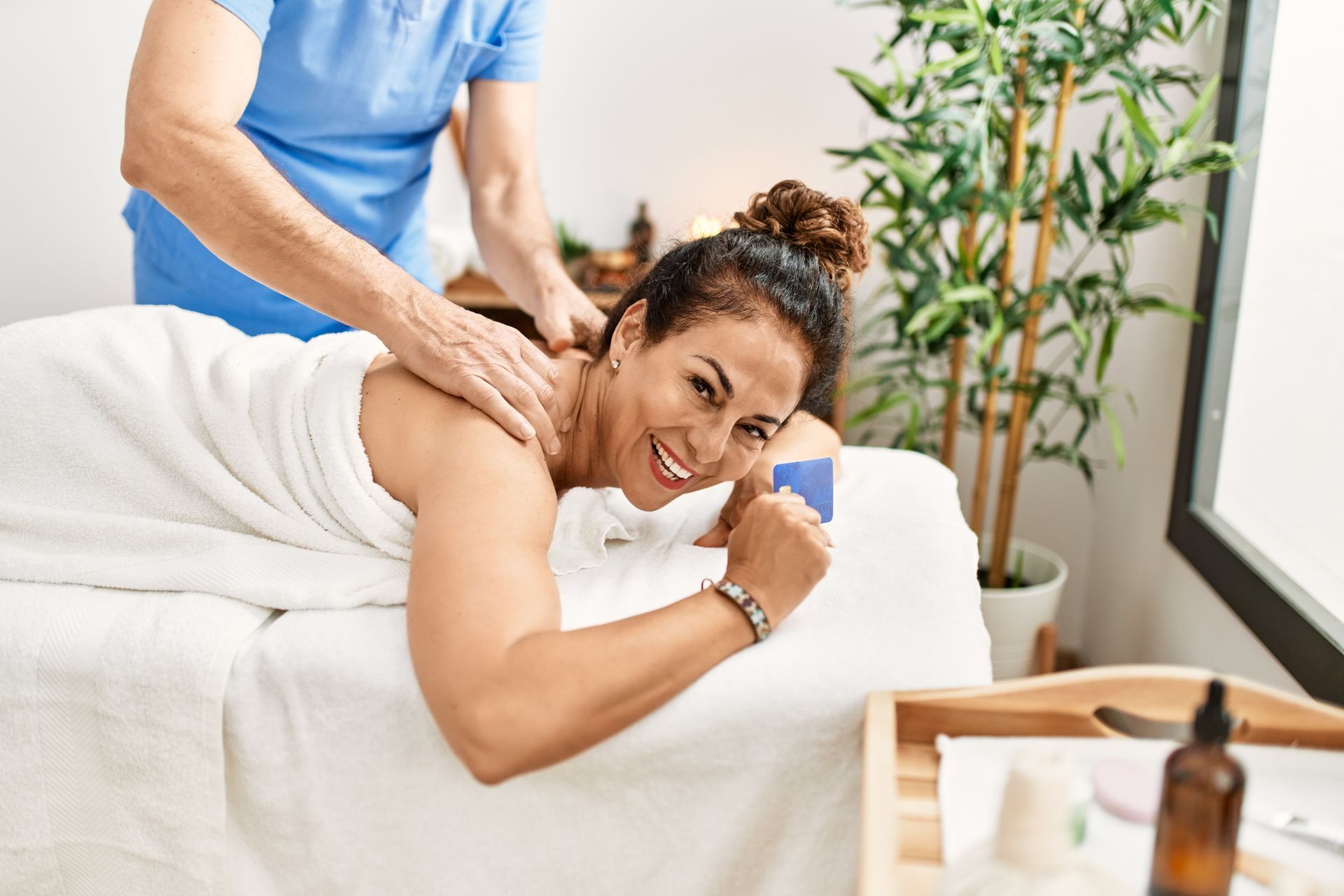 A woman is laying on a massage table getting a massage.