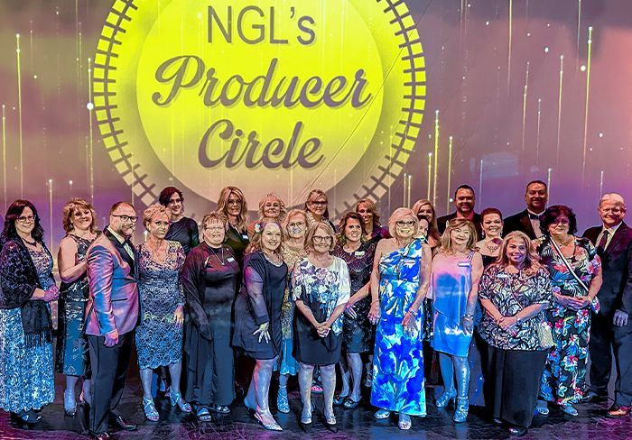 Group of people posing for a photo under a