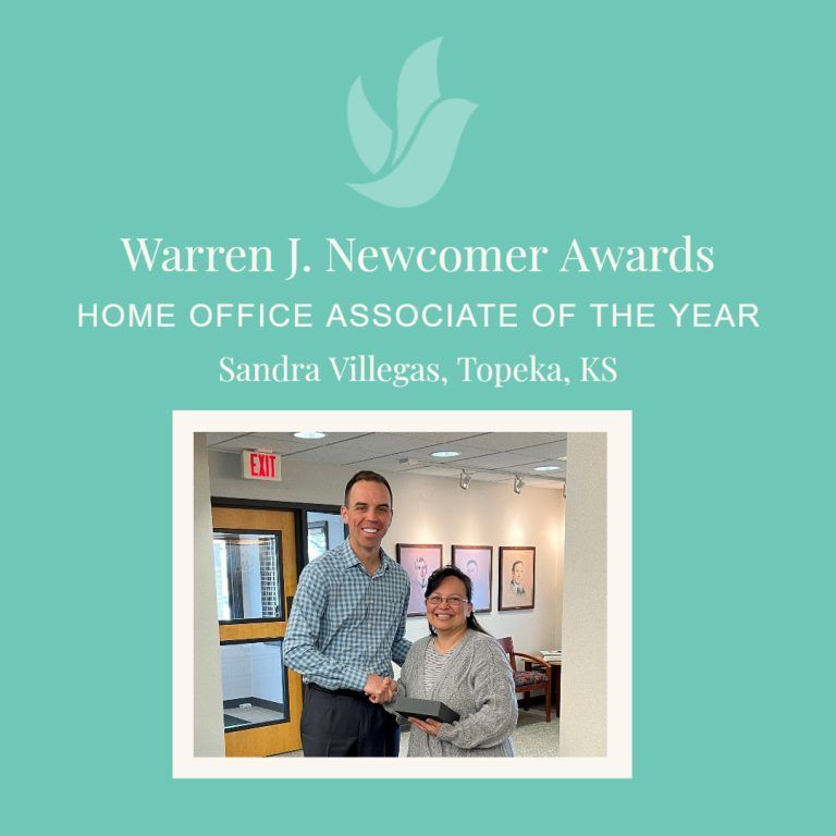 Man presenting an award to Sandra Villegas in Topeka, Kansas. Turquoise background, logo at top.