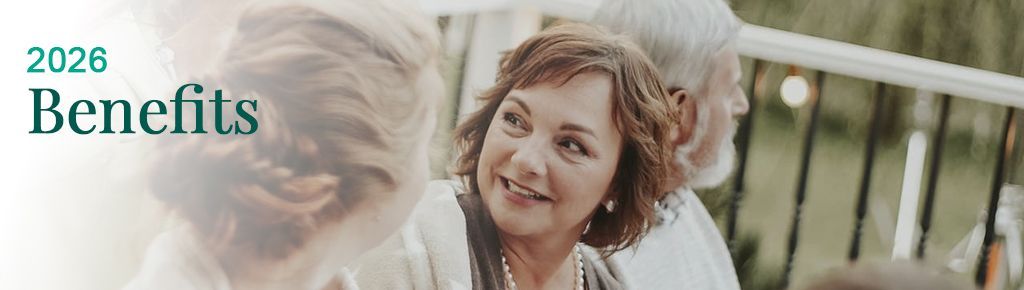 Four people sitting outside on a deck talking