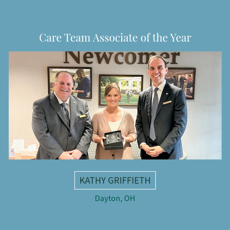 Kathy Griffieth, Dayton, OH, Care Team Associate of the Year, poses with two men in an office setting.