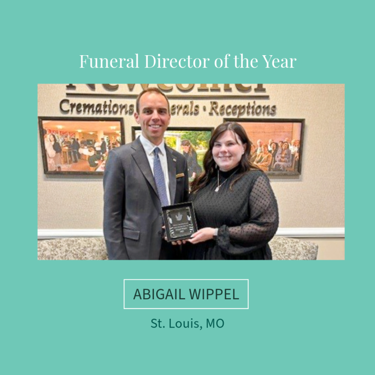Abigail Wippel, St. Louis, MO, holding plaque, smiling with man. Background: funeral home sign and artwork.