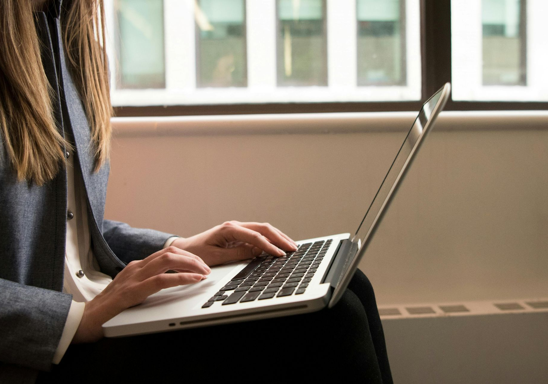 The front door of a house with a porch and plants in front of it.