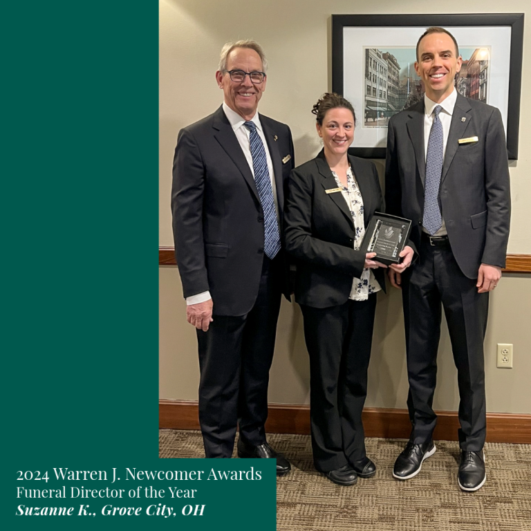 Three people at an award ceremony; Suzanne K. (center) holding an award for Funeral Director of the Year, Grove City, OH.
