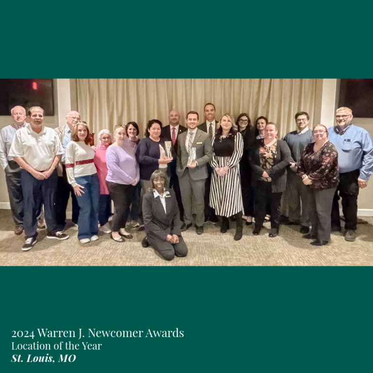 Group photo at the 2024 Warren J. Newcomer Awards, St. Louis, MO. People holding awards, smiling.
