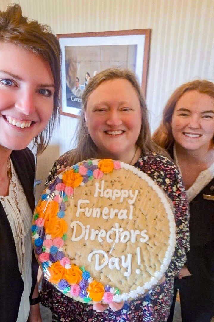 Group of women smiling, posing with a blank canvas in an art studio.