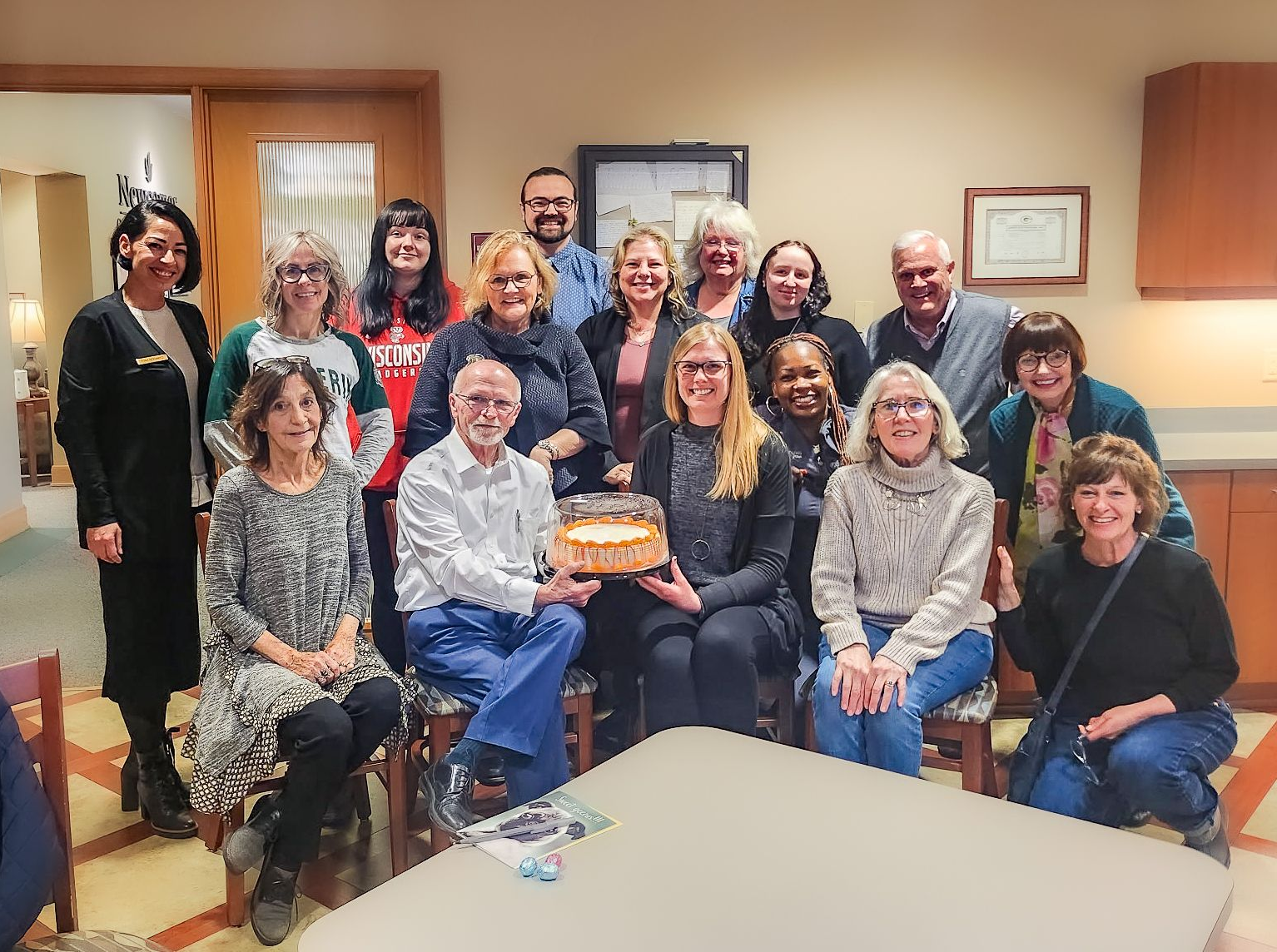The front door of a house with a porch and plants in front of it.