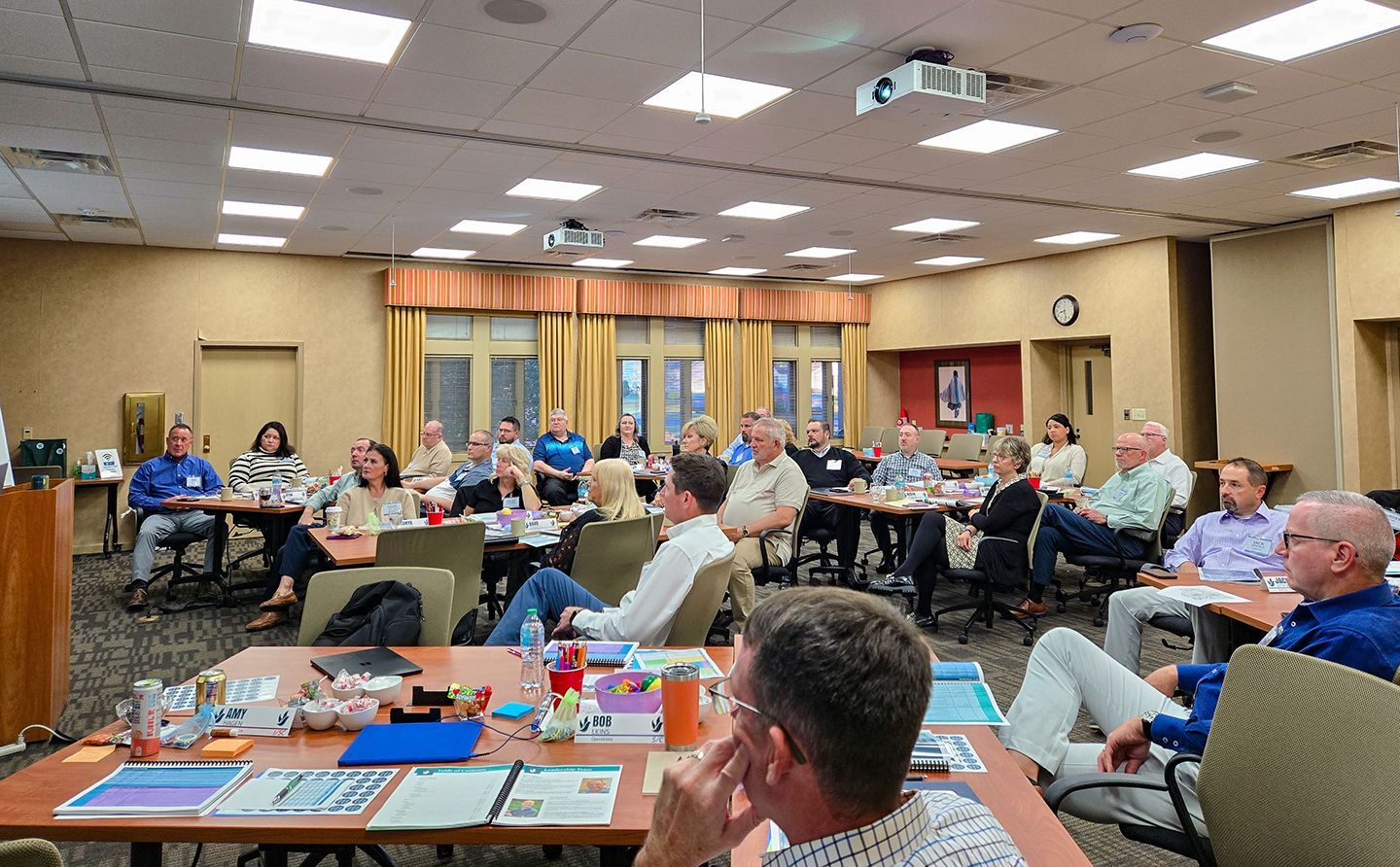 The front door of a house with a porch and plants in front of it.