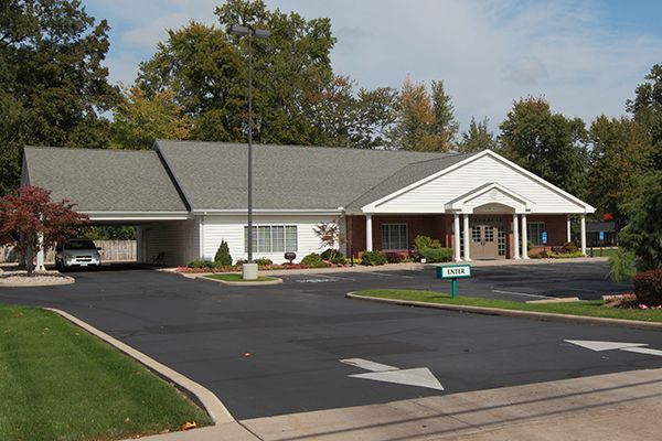 Bank building with covered drive-thru, asphalt parking, and landscaping.
