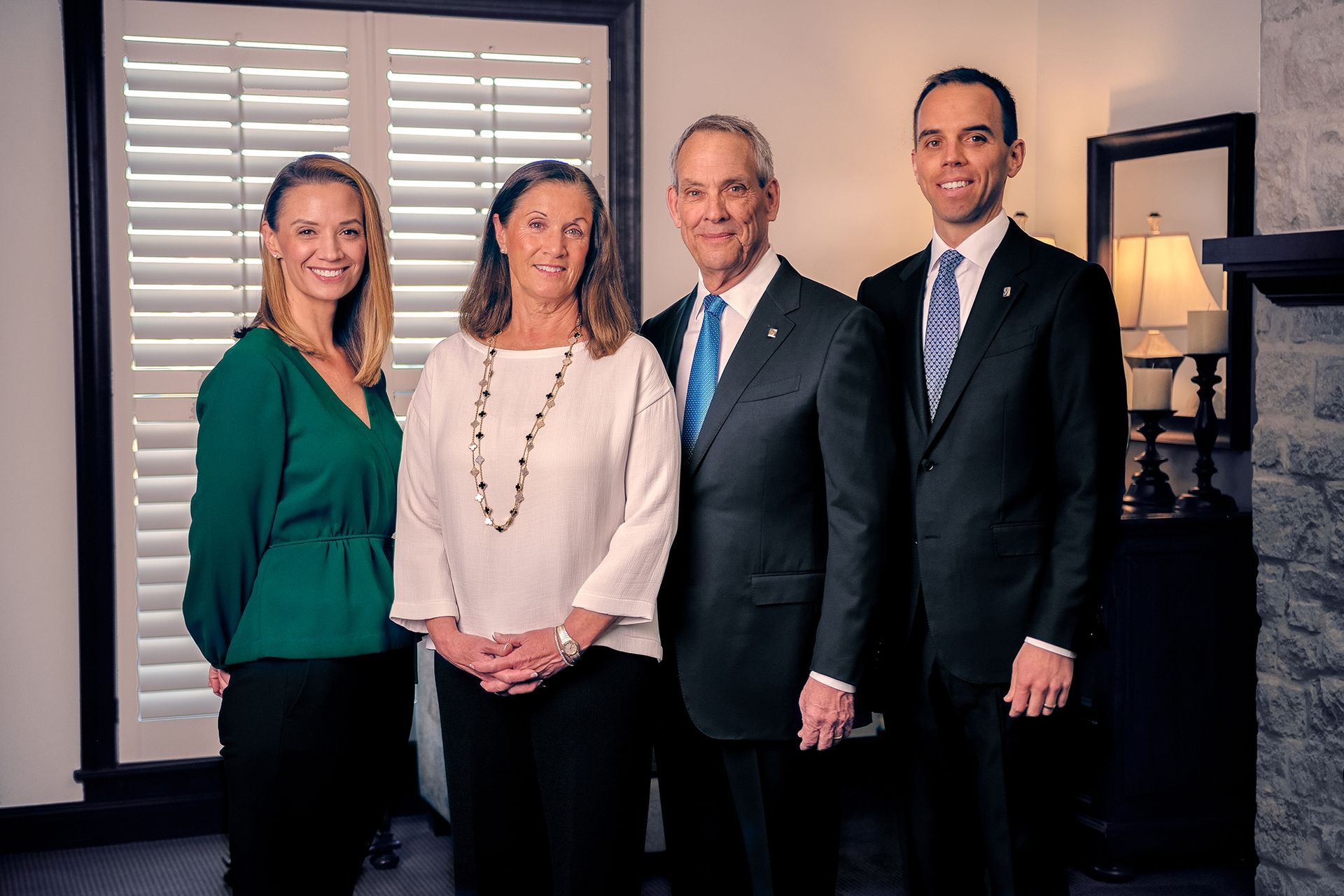 The front door of a house with a porch and plants in front of it.