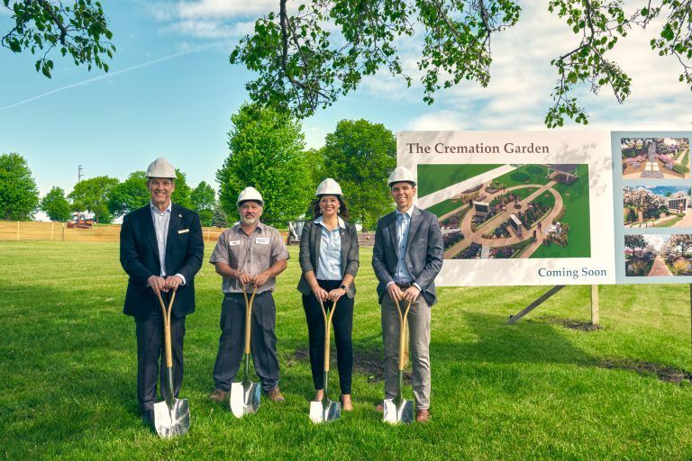 Four people with shovels at a groundbreaking ceremony for The Cremation Garden.